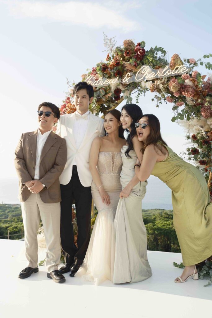 Bride and groom posing outdoors with guests at a luxury destination wedding in Okinawa, Japan
