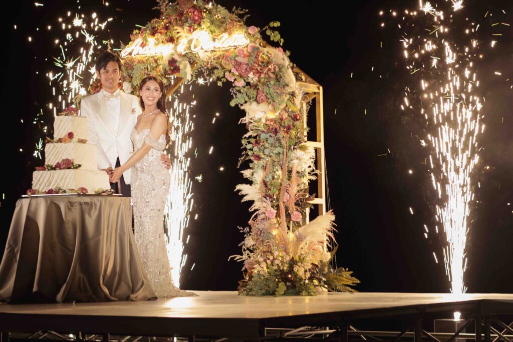 Wedding cake cutting with fireworks at a luxury destination wedding in Okinawa, Japan
