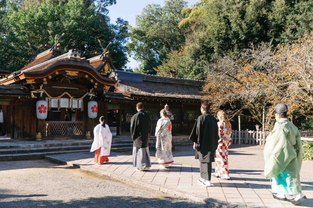 Shinto priest and family witnessing a traditional Japanese wedding ceremony in Kyoto
