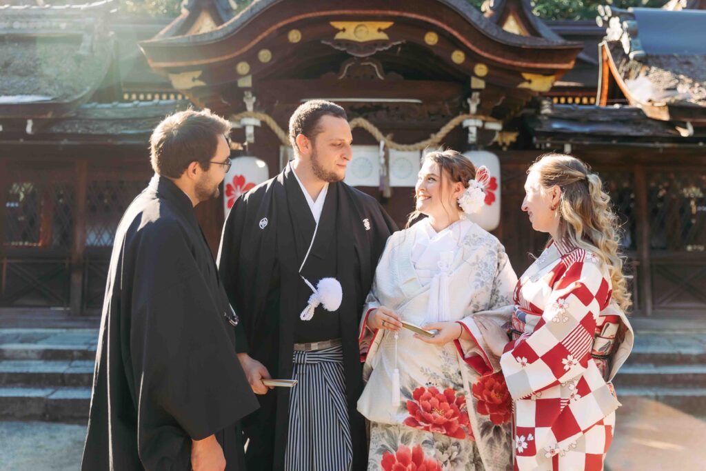 Family celebrating together at a traditional Shinto shrine during an intimate autumn wedding in Kyoto
