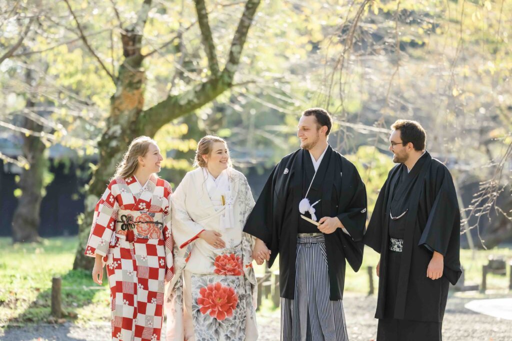 Family celebrating together at a traditional Shinto shrine during an intimate autumn wedding in Kyoto
